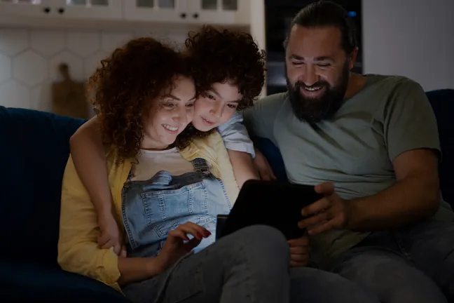 Family streaming an NFHS Network game together on a tablet